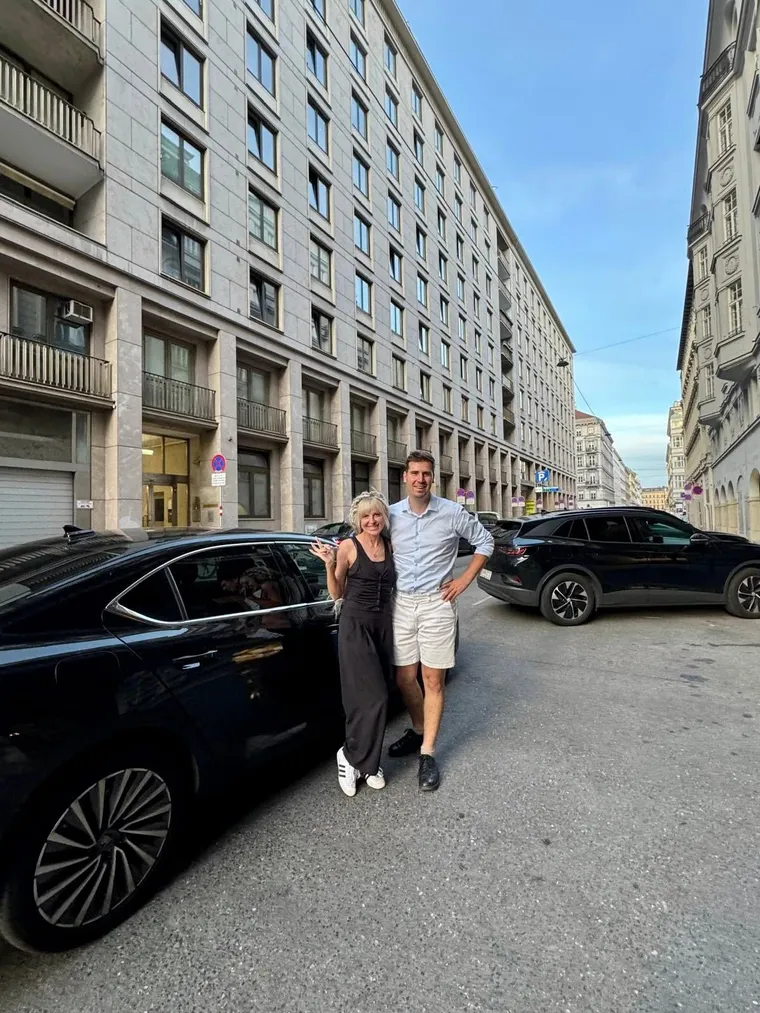 Matt with a client next to his car on a city street